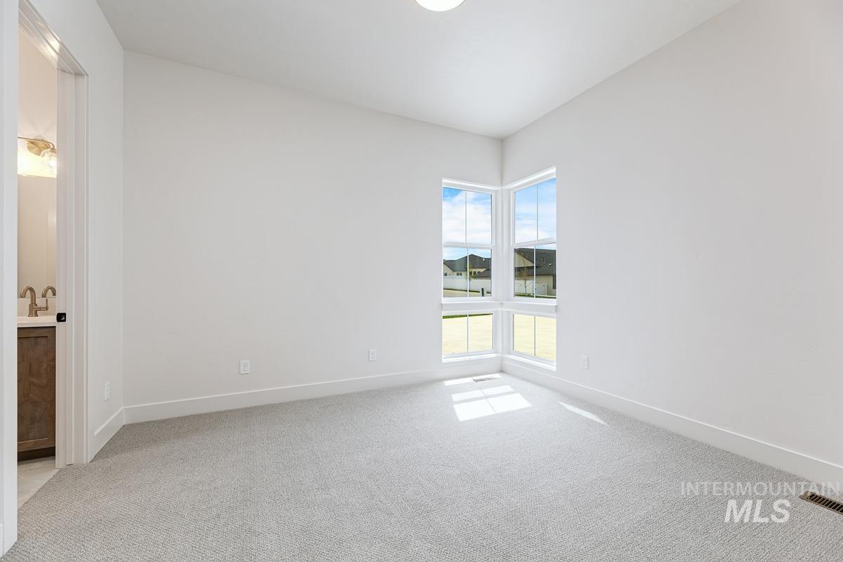 13758 North Ruffed Grouse Way Boise, ID 83714 - Photo 28 of 45 Empty room with light carpet and baseboards