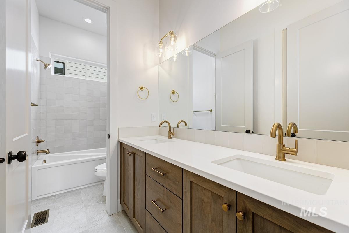 13758 North Ruffed Grouse Way Boise, ID 83714 - Photo 29 of 45 Full bathroom featuring double vanity and shower / bathtub combination