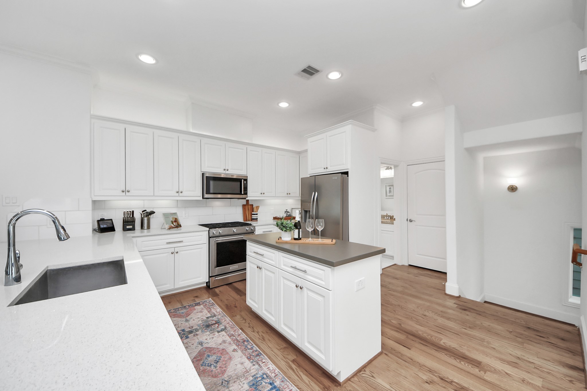 1628 West 24th Street Houston, TX 77008 - Photo 5 of 41 Wide open spaces and soaring ceilings create a wonderful entertaining flow, and the 2nd floor half bath is tucked behind the kitchen.