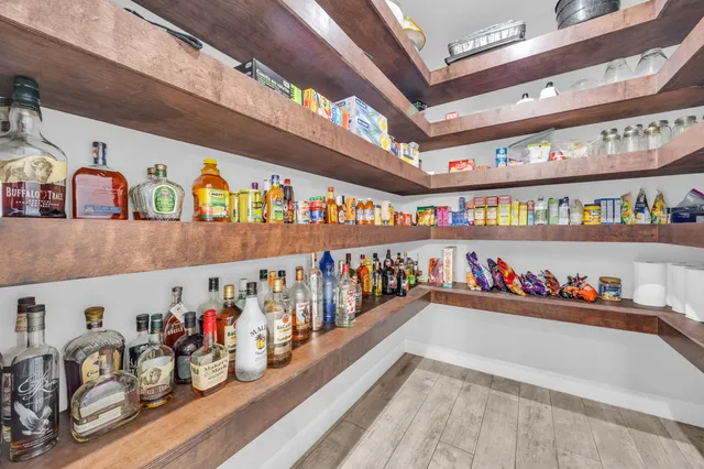 a bathroom with a granite countertop sink a mirror and a shower