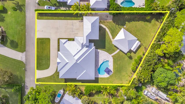 an aerial view of a house with a swimming pool