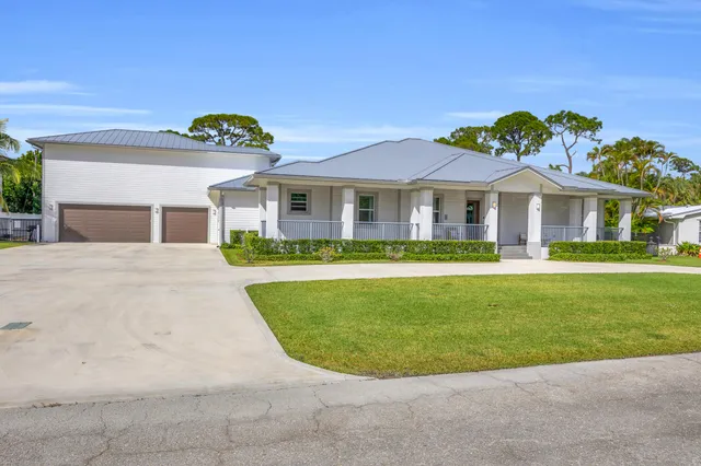 a living room with furniture ceiling fan and a window