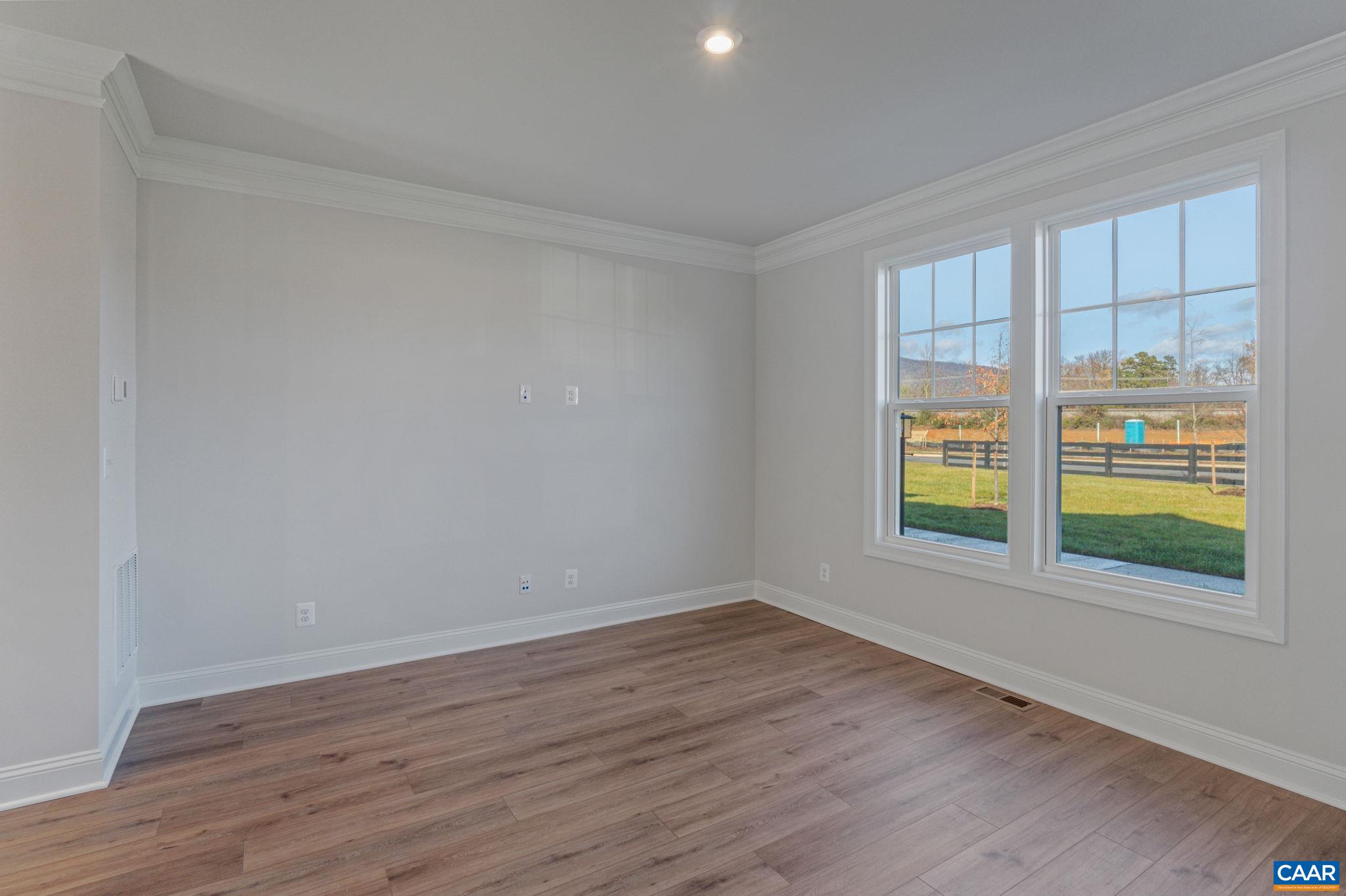 2201 Woodburn Road Charlottesville, VA 22901 - Photo 9 of 43 a view of an empty room with wooden floor and a window