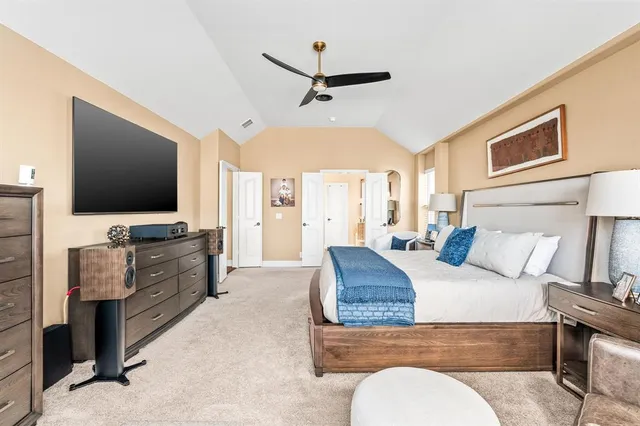 a bedroom with bed and a chandelier