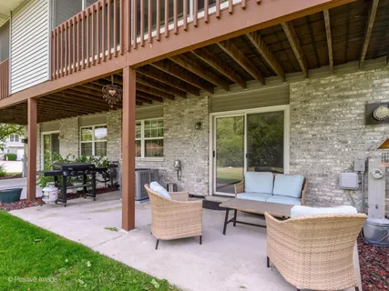 a patio with patio couch and outdoor seating