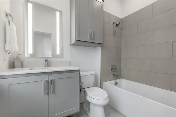 a bathroom with a sink a toilet and bathtub
