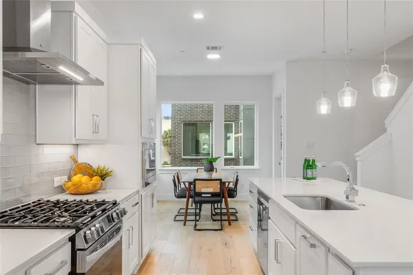 a kitchen with a sink appliances and cabinets
