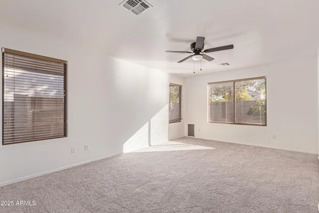 a view of a livingroom with a ceiling fan and window