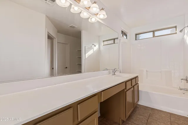 a bathroom with a sink a mirror and a bathtub