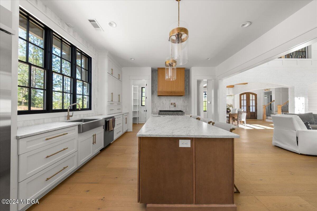 110 Birch Circle Forsyth, GA 31029 - Photo 13 of 44 a large kitchen with stainless steel appliances kitchen island granite countertop a stove and a sink