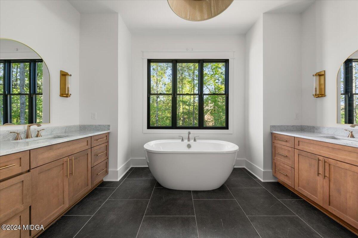 110 Birch Circle Forsyth, GA 31029 - Photo 21 of 44 a spacious bathroom with a bathtub sink and mirror