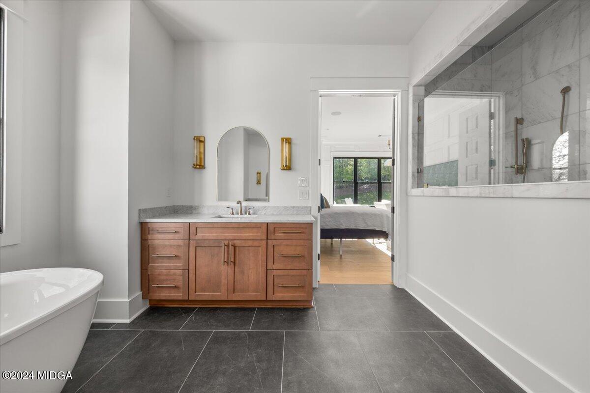 110 Birch Circle Forsyth, GA 31029 - Photo 22 of 44 a bathroom with a granite countertop sink a toilet and bathtub