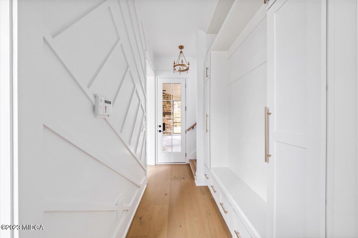 110 Birch Circle Forsyth, GA 31029 - Photo 24 of 44 a view of a hallway with wooden floor and staircase