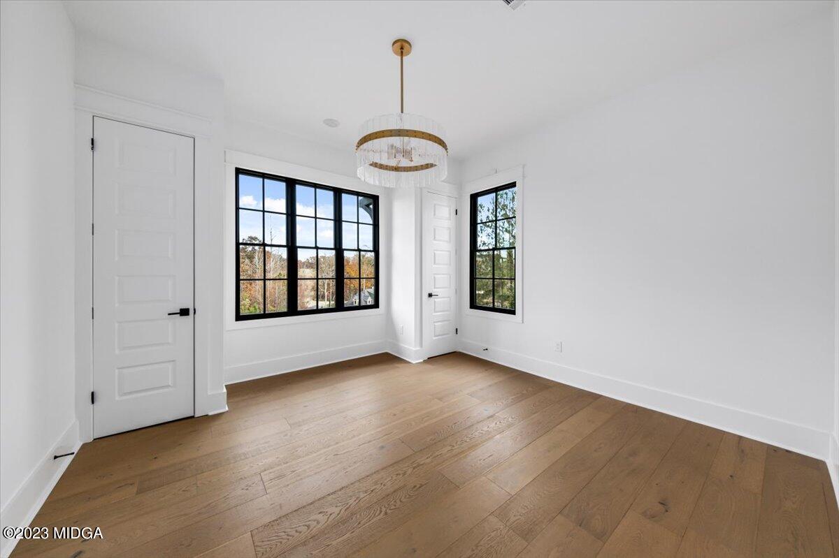 110 Birch Circle Forsyth, GA 31029 - Photo 27 of 44 a view of an empty room with window and hardwood floor