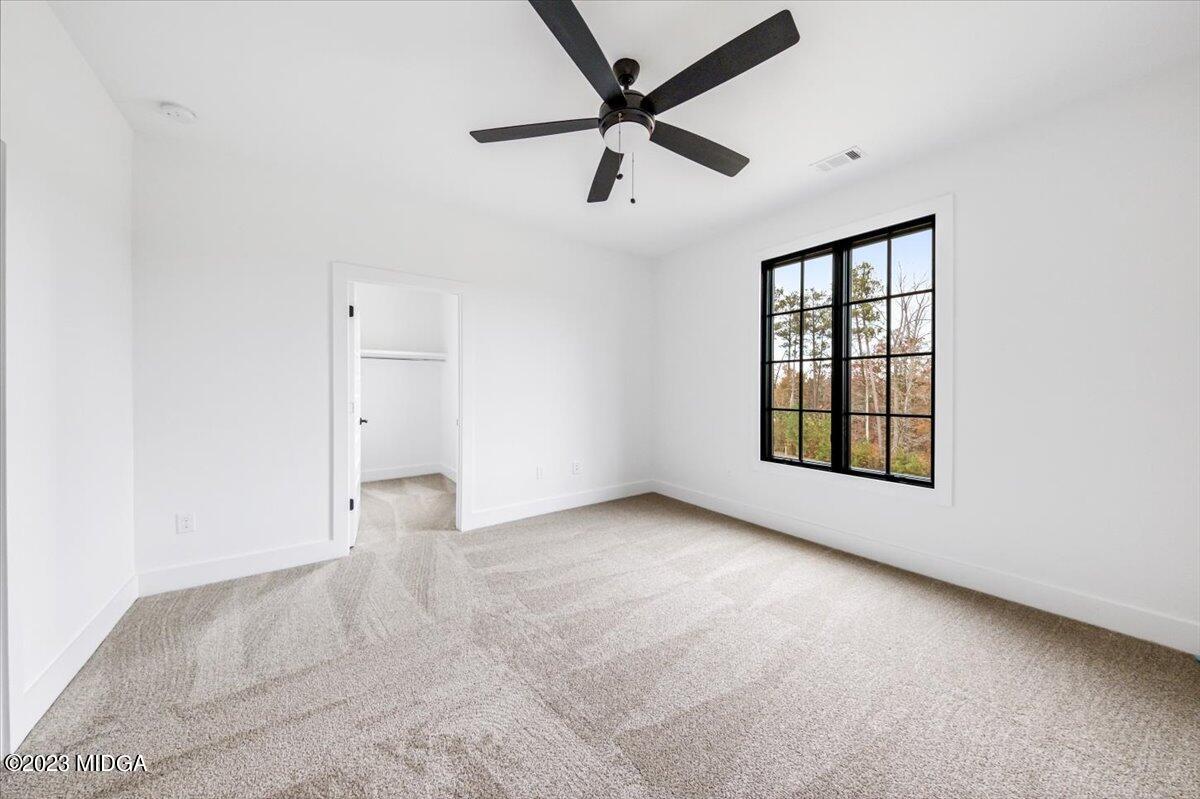 110 Birch Circle Forsyth, GA 31029 - Photo 33 of 44 an empty room with windows and fan