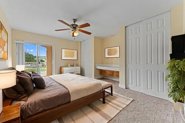 a bedroom with a bed a fireplace and a window