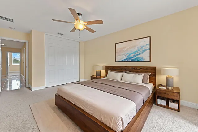 a bedroom with a large bed and a chandelier