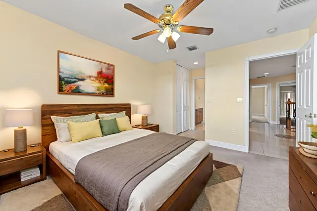 a spacious bedroom with a bed and a chandelier