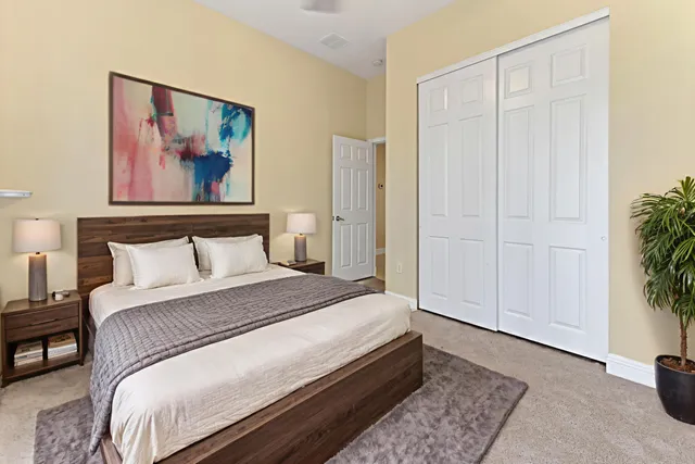 a bedroom with bed and cupboard