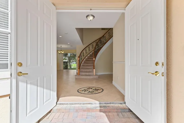 a view of a hallway with wooden floor and entryway