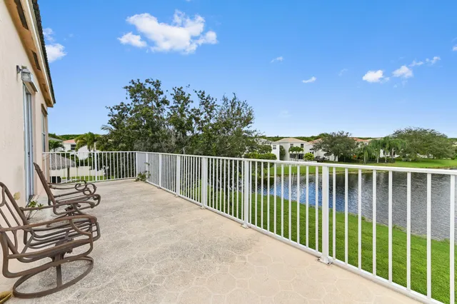 a view of a balcony with chair and wooden fence