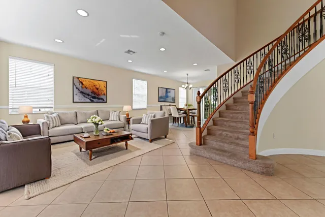 a living room with furniture and stairs