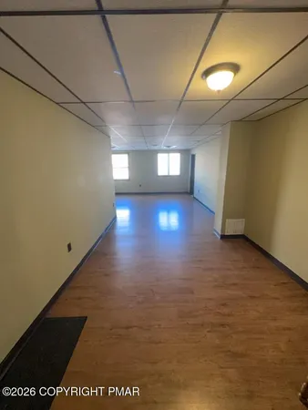 a view of a hallway with wooden floor