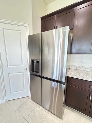 a view of a refrigerator in kitchen and wooden floor