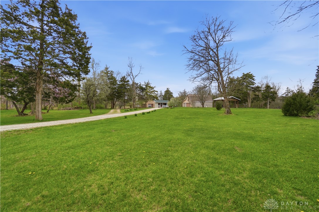 7553 Coffin Station Road Springfield, OH 45502 - Photo 94 of 95 A winding gravel path leads to a home nestled amidst lush green surroundings.