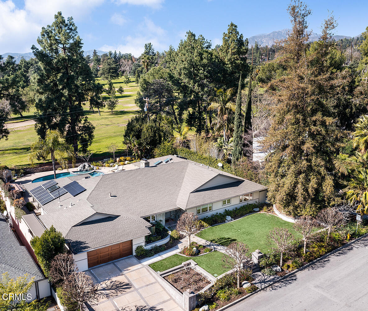 an aerial view of a house with outdoor space and lake view in back