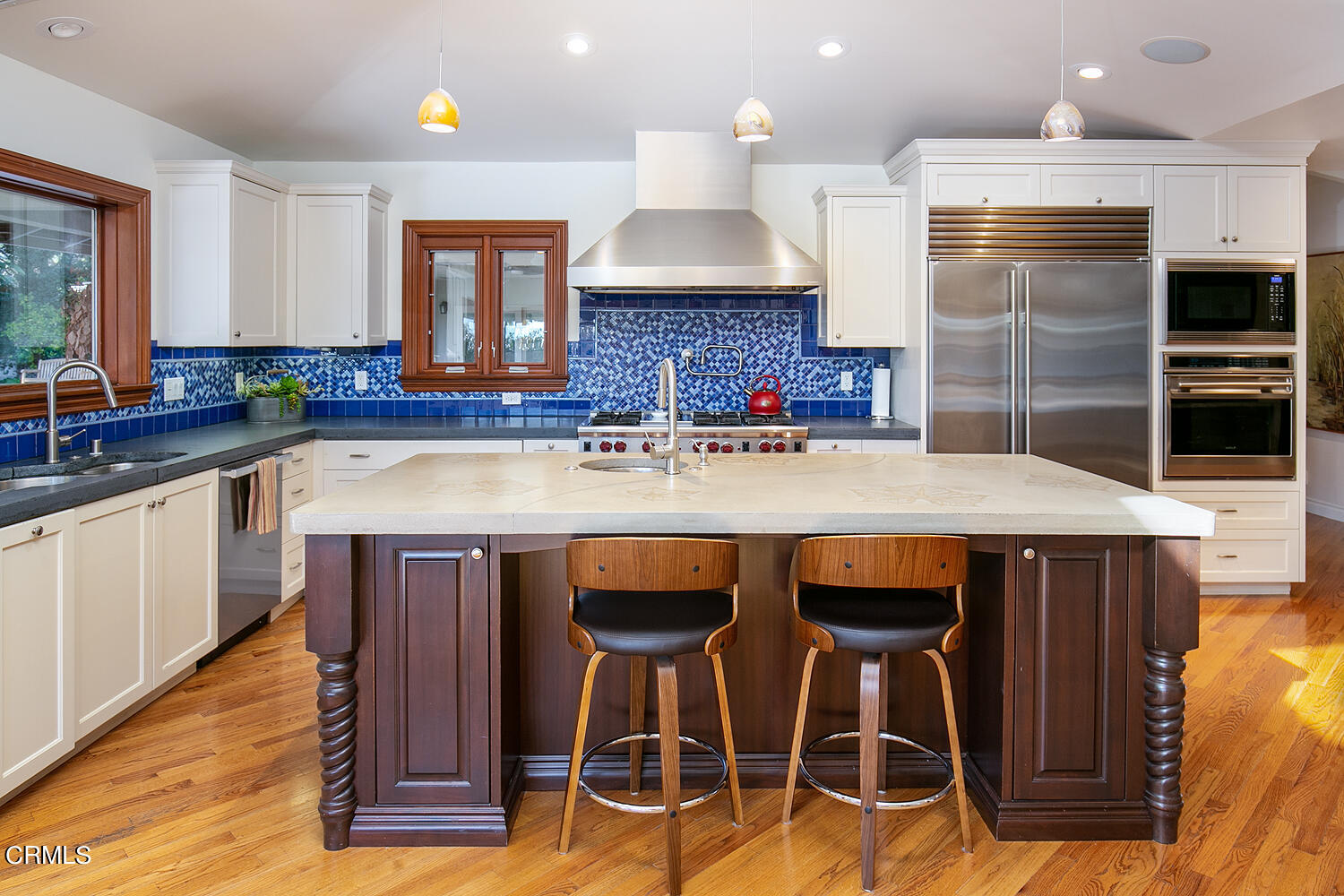 1563 Meadowbrook Road Altadena, CA 91001 - Photo 15 of 38 a kitchen with stainless steel appliances granite countertop a table chairs in it and wooden floors