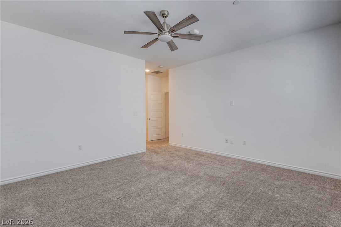 2555 Hampton Road, Unit 8206 Henderson, NV 89052 - Photo 16 of 25 A spacious room offers comfortable carpet flooring and a ceiling fan for year-round comfort.