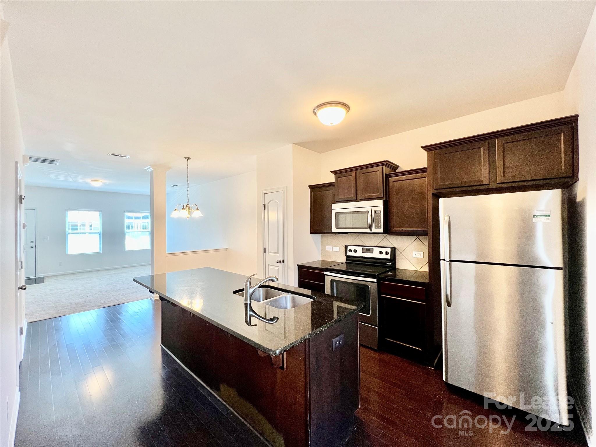 12712 Persimmon Tree Drive Charlotte, NC 28273 - Photo 9 of 9 a kitchen with kitchen island a sink appliances and cabinets