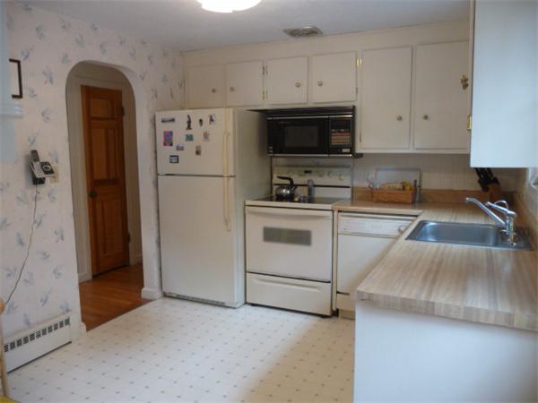 40 Harold Street Sharon, MA 02067 - Photo 9 of 22 a kitchen with white cabinets and white appliances