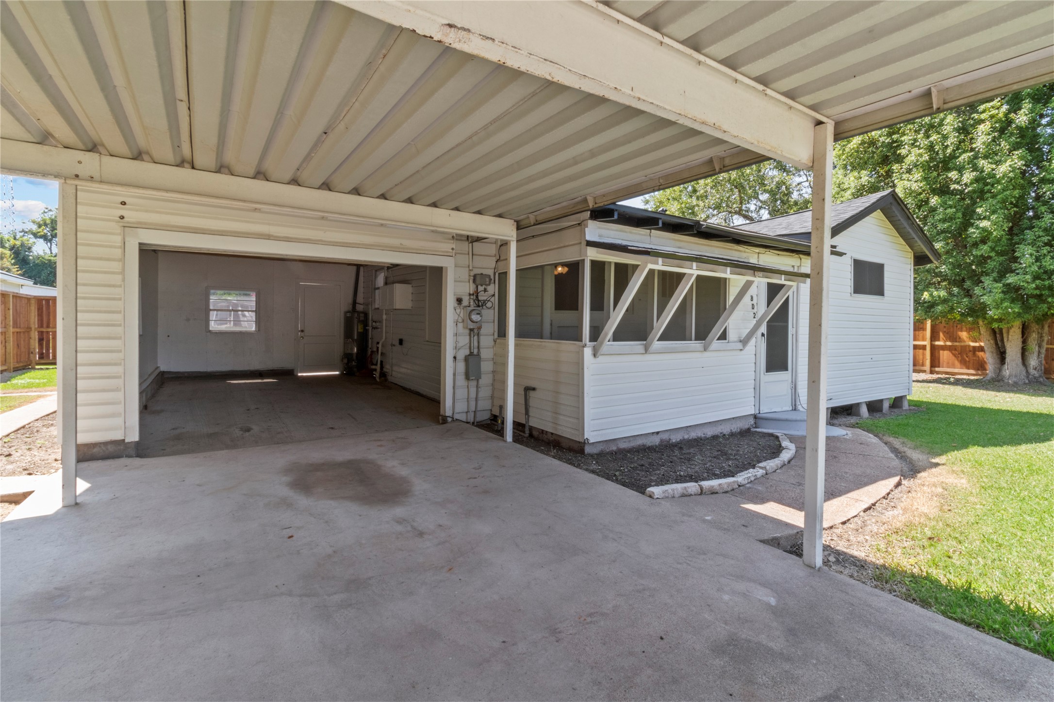 802 Collins Street Dayton, TX 77535 - Photo 12 of 12 a view of a house with a yard and garage