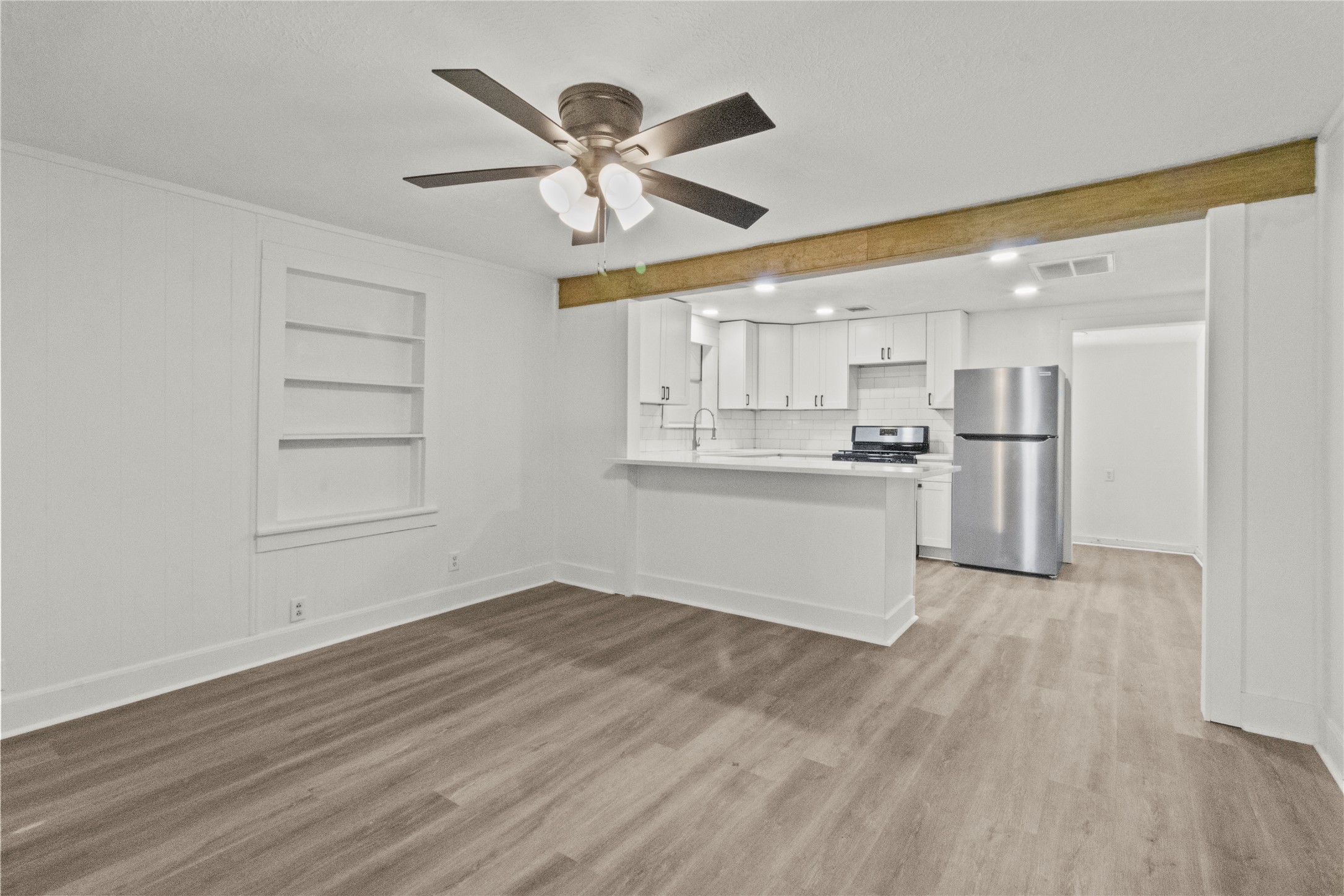 802 Collins Street Dayton, TX 77535 - Photo 2 of 12 a view of a kitchen with a dishwasher and wooden floor