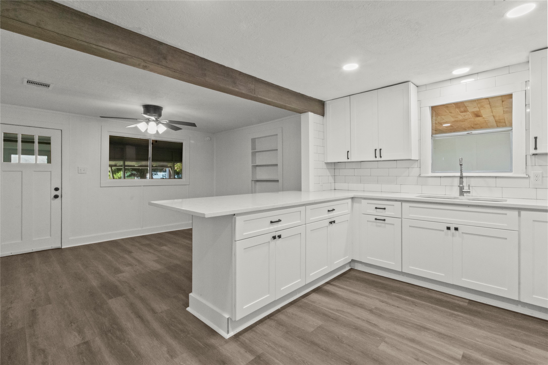 802 Collins Street Dayton, TX 77535 - Photo 6 of 12 a kitchen with a sink cabinets and wooden floor