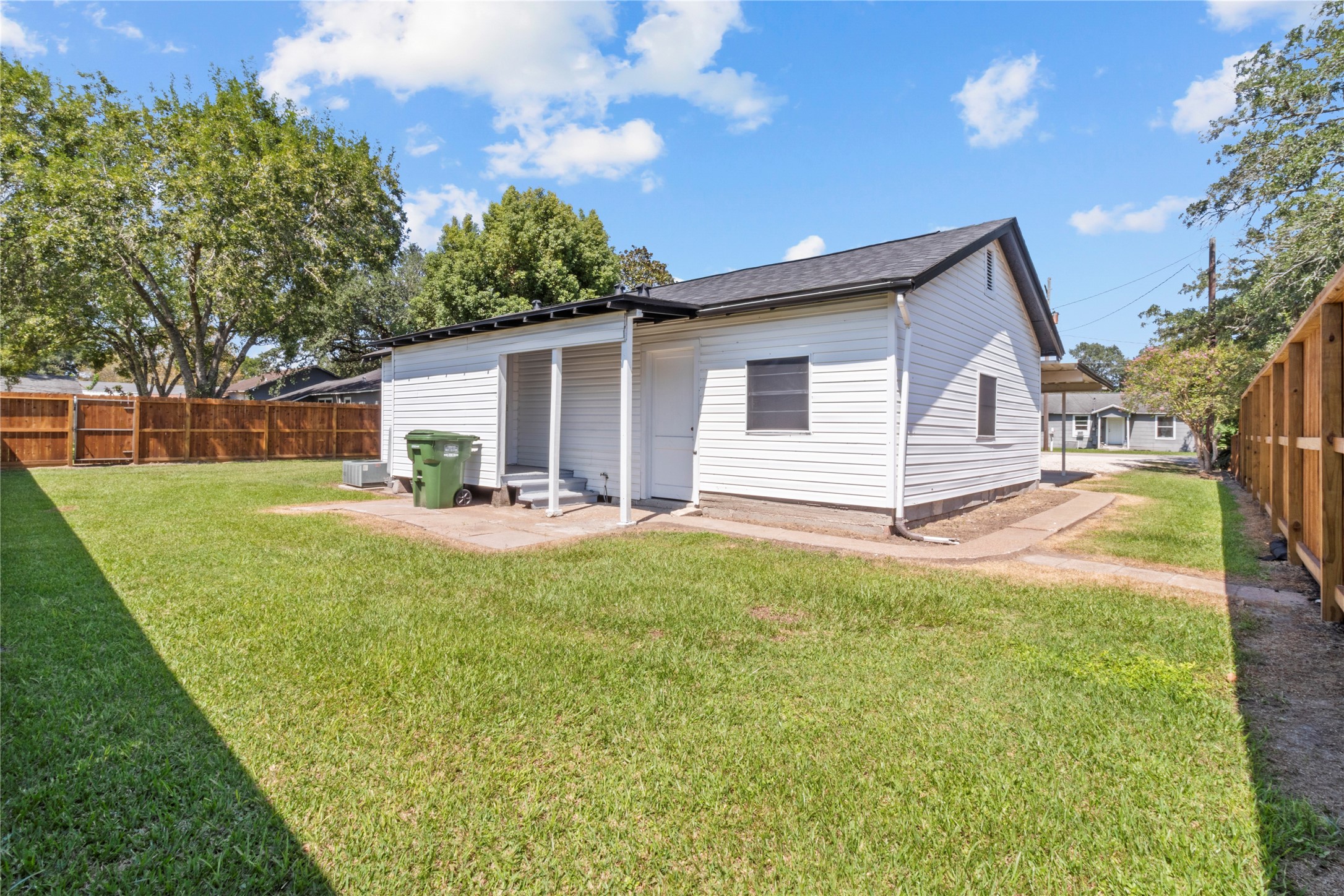 802 Collins Street Dayton, TX 77535 - Photo 9 of 12 a view of a house with backyard and sitting area