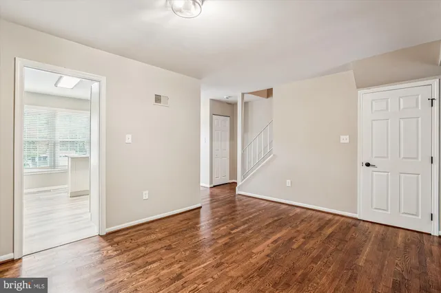a view of an empty room with wooden floor