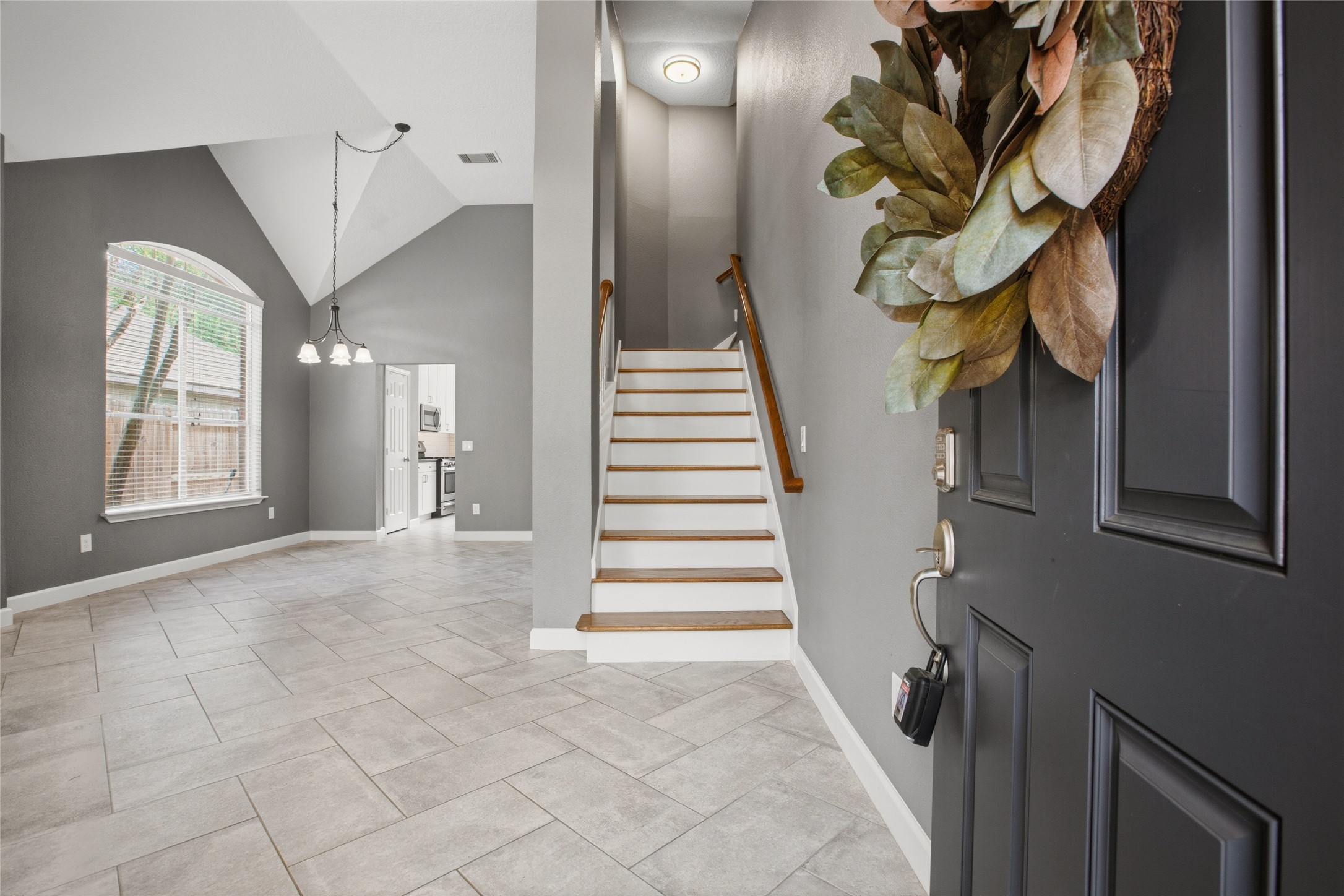 20907 Nettlebrook Lane Katy, TX 77450 - Photo 5 of 46 Inside, the ceiling height immediately changes the energy. Everything feels lifted and open. Sunlight pours through the front windows, casting a soft glow across the tile floors.