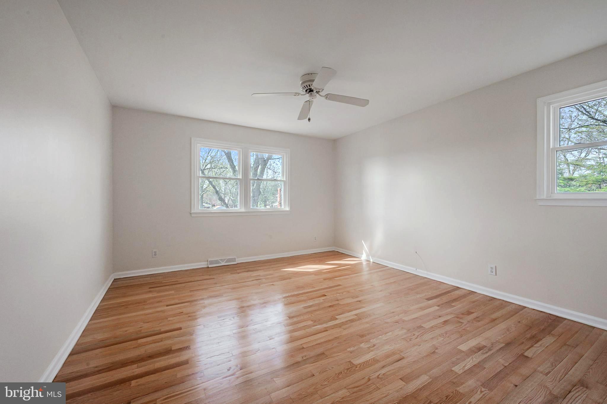 4 Phoenix Drive Bear, DE 19701 - Photo 13 of 21 an empty room with wooden floor ceiling fan and windows
