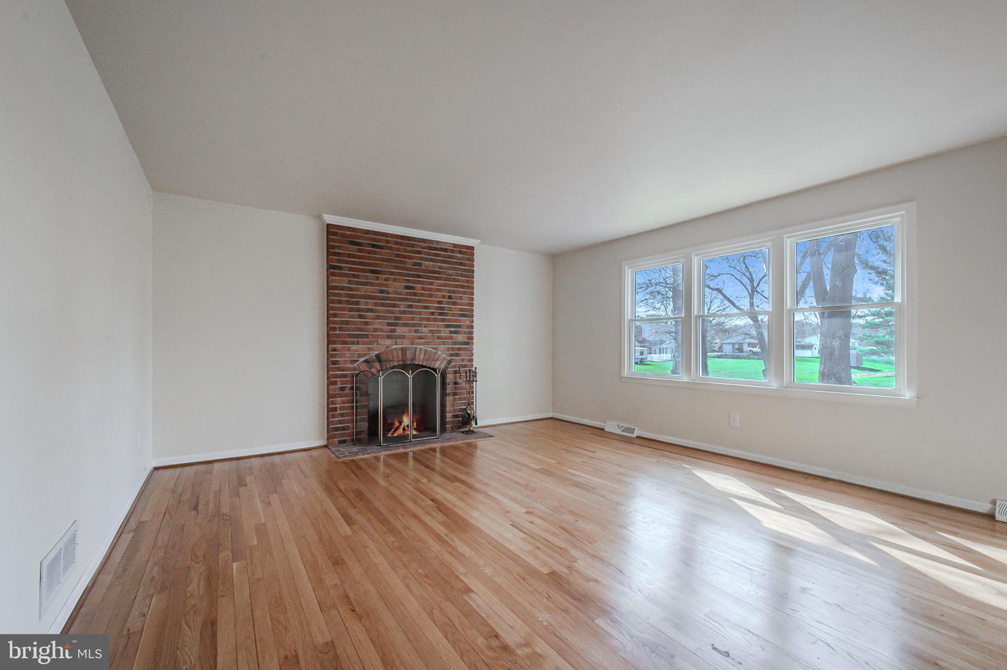 4 Phoenix Drive Bear, DE 19701 - Photo 5 of 21 a view of an empty room with wooden floor and a window