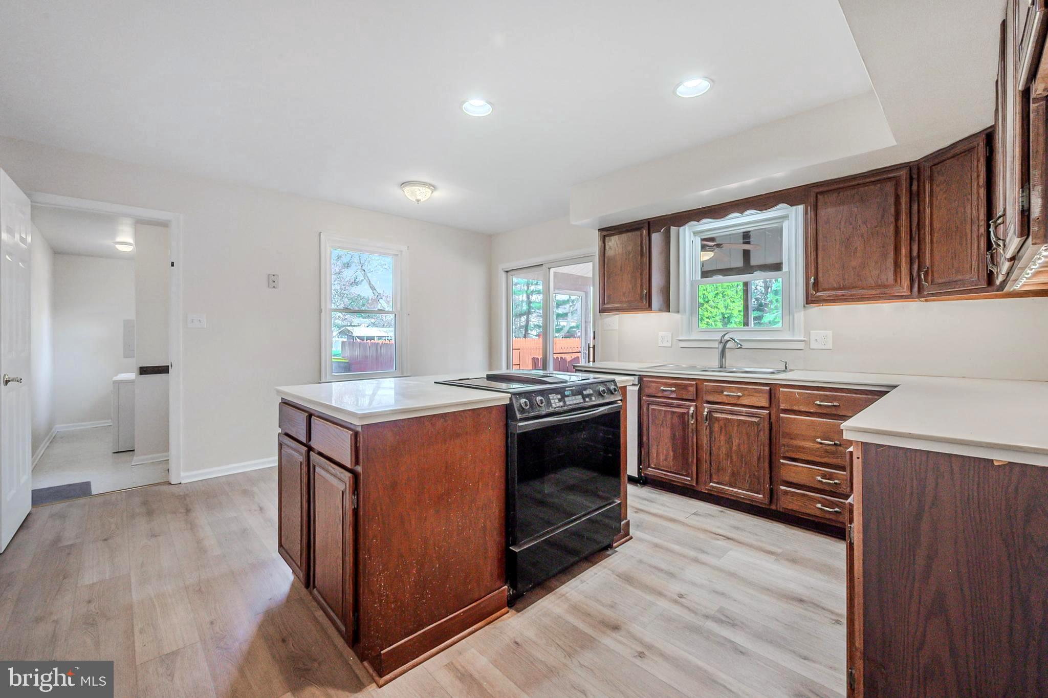 4 Phoenix Drive Bear, DE 19701 - Photo 7 of 21 a kitchen with granite countertop a stove top oven sink and cabinets
