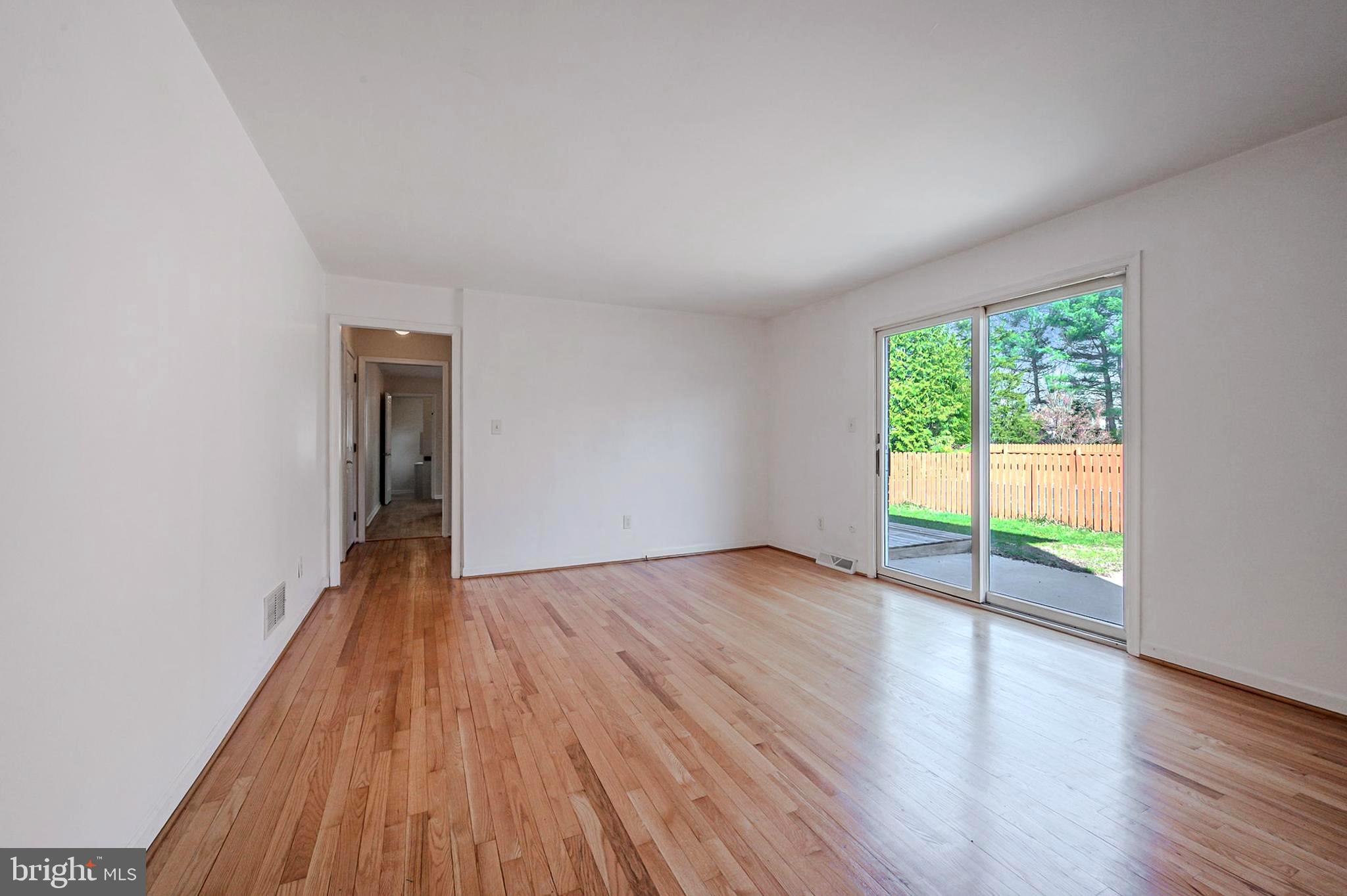 4 Phoenix Drive Bear, DE 19701 - Photo 8 of 21 a view of an empty room with wooden floor and a window