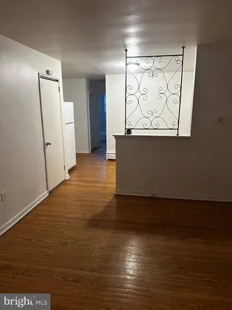 an empty room with wooden floor and a window