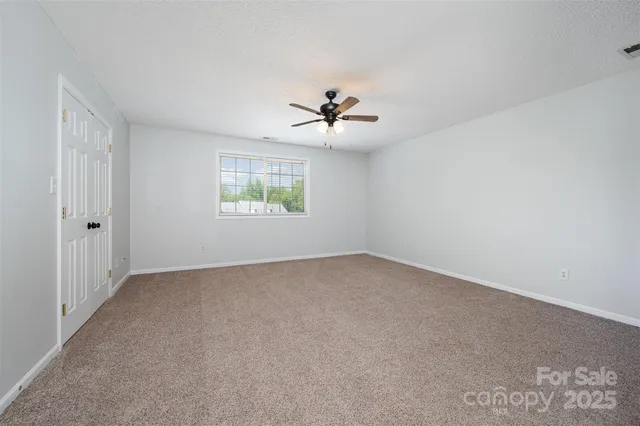 a view of empty room with ceiling fan