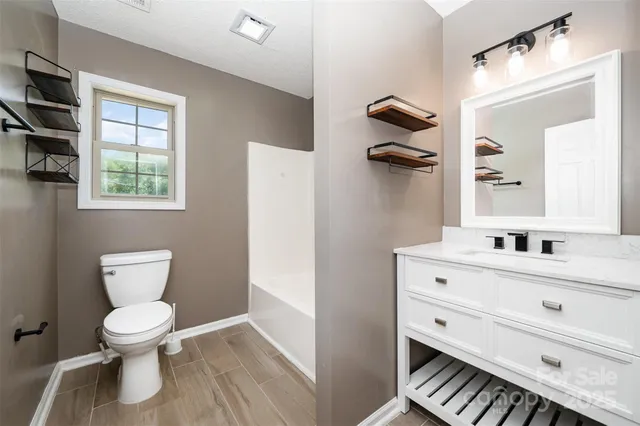 a front view of a house with a yard and a garage