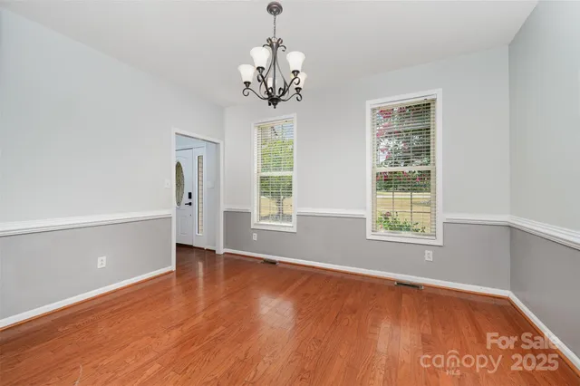 a view of an empty room with a ceiling fan