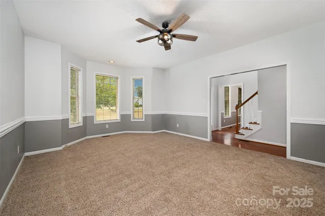 a view of an empty room with a fireplace and a window