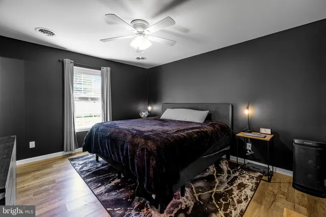a bedroom with a large bed and a chandelier